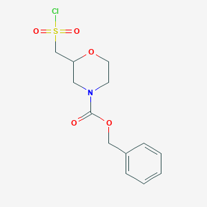 molecular formula C13H16ClNO5S B3048709 Benzyl 2-[(chlorosulfonyl)methyl]morpholine-4-carboxylate CAS No. 1803584-56-6