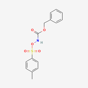 molecular formula C15H15NO5S B3055393 苄基[(4-甲苯-1-磺酰)氧基]氨基甲酸酯 CAS No. 64420-86-6