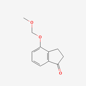 molecular formula C11H12O3 B3085560 2,3-dihydro-4-(methoxymethoxy)-1H-inden-1-one CAS No. 115757-63-6