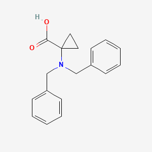 molecular formula C18H19NO2 B3089288 1-(N,N-dibenzylamino)cyclopropanecarboxylic acid CAS No. 119111-63-6