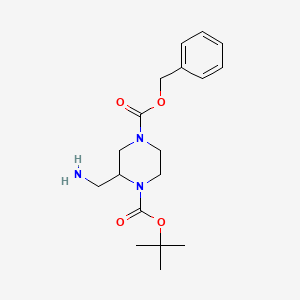 molecular formula C18H27N3O4 B3089933 4-Benzyl 1-tert-butyl 2-(aminomethyl)piperazine-1,4-dicarboxylate CAS No. 1202800-72-3