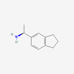 molecular formula C11H15N B3090579 (1S)-1-(2,3-dihydro-1H-inden-5-yl)ethanamine CAS No. 1212278-77-7