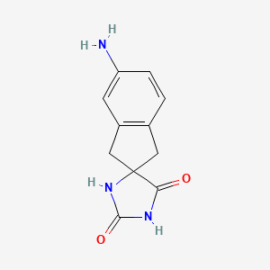 molecular formula C11H11N3O2 B3126649 5'-Amino-1',3'-dihydrospiro[imidazolidine-4,2'-indene]-2,5-dione CAS No. 33584-67-7