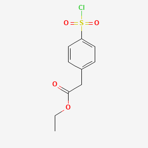 B3161654 (4-Chlorosulfonyl-phenyl)-acetic acid ethyl ester CAS No. 87202-52-6