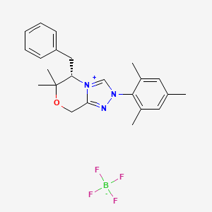 molecular formula C23H28BF4N3O B3179138 (S)-5-Benzyl-2-mesityl-6,6-dimethyl-6,8-dihydro-5H-[1,2,4]triazolo[3,4-c][1,4]oxazin-2-ium tetrafluoroborate CAS No. 925706-40-7