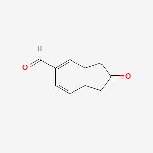 molecular formula C10H8O2 B3185663 1H-Indene-5-carboxaldehyde, 2,3-dihydro-2-oxo- CAS No. 1187243-13-5