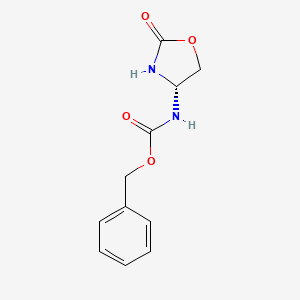molecular formula C11H12N2O4 B3189275 Carbamic acid, [(4S)-2-oxo-4-oxazolidinyl]-, phenylmethyl ester CAS No. 306773-77-3