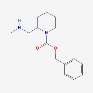 molecular formula C15H22N2O2 B3234295 2-Methylaminomethyl-piperidine-1-carboxylic acid benzyl ester CAS No. 1353971-44-4
