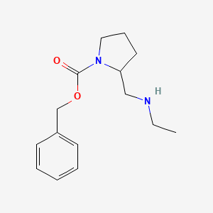 molecular formula C15H22N2O2 B3234787 2-Ethylaminomethyl-pyrrolidine-1-carboxylic acid benzyl ester CAS No. 1353981-46-0