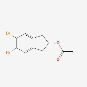 B3289934 5,6-Dibromo-2,3-dihydro-1H-inden-2-yl acetate CAS No. 862135-55-5