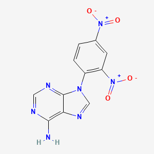 molecular formula C11H7N7O4 B3366344 9-(2,4-Dinitrophenyl)adenine CAS No. 136112-73-7