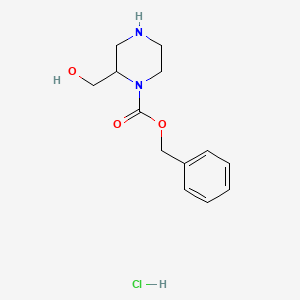 molecular formula C13H19ClN2O3 B3376465 Benzyl 2-(hydroxymethyl)piperazine-1-carboxylate hydrochloride CAS No. 1203013-92-6