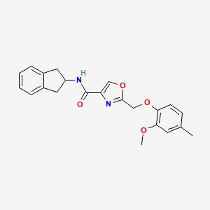 N-(2,3-dihydro-1H-inden-2-yl)-2-[(2-methoxy-4-methylphenoxy)methyl]-1,3-oxazole-4-carboxamide