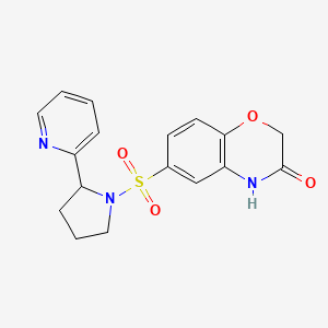 molecular formula C17H17N3O4S B5500856 6-{[2-(2-吡啶基)-1-吡咯烷基]磺酰基}-2H-1,4-苯并恶嗪-3(4H)-酮 