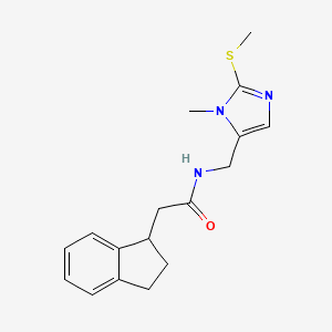 molecular formula C17H21N3OS B5595622 2-(2,3-dihydro-1H-inden-1-yl)-N-{[1-methyl-2-(methylthio)-1H-imidazol-5-yl]methyl}acetamide 
