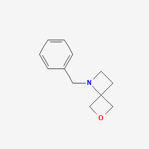 molecular formula C12H15NO B567053 1-Benzyl-6-oxa-1-azaspiro[3.3]heptane CAS No. 1223573-38-3
