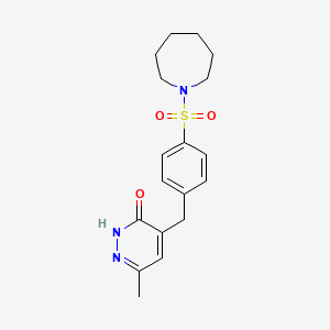 molecular formula C18H23N3O3S B6069135 4-[4-(1-azepanylsulfonyl)benzyl]-6-methyl-3(2H)-pyridazinone 