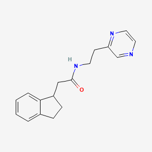 molecular formula C17H19N3O B6090479 2-(2,3-dihydro-1H-inden-1-yl)-N-[2-(2-pyrazinyl)ethyl]acetamide 