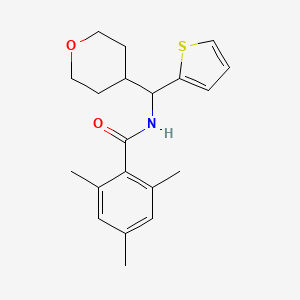 2,4,6-trimethyl-N-[(oxan-4-yl)(thiophen-2-yl)methyl]benzamide