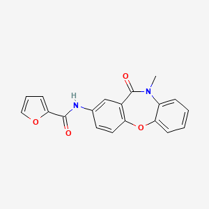N-{9-methyl-10-oxo-2-oxa-9-azatricyclo[9.4.0.0^{3,8}]pentadeca-1(11),3(8),4,6,12,14-hexaen-13-yl}furan-2-carboxamide