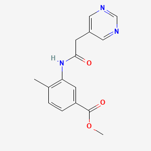 molecular formula C15H15N3O3 B6624762 Methyl 4-methyl-3-[(2-pyrimidin-5-ylacetyl)amino]benzoate 