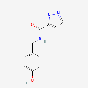 molecular formula C12H13N3O2 B6643471 N-[(4-hydroxyphenyl)methyl]-2-methylpyrazole-3-carboxamide 