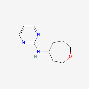 molecular formula C10H15N3O B6749096 N-(oxepan-4-yl)pyrimidin-2-amine 