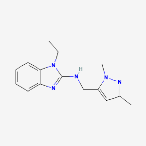 molecular formula C15H19N5 B6750039 N-[(2,5-dimethylpyrazol-3-yl)methyl]-1-ethylbenzimidazol-2-amine 