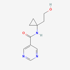 molecular formula C10H13N3O2 B6962627 N-[1-(2-hydroxyethyl)cyclopropyl]pyrimidine-5-carboxamide 