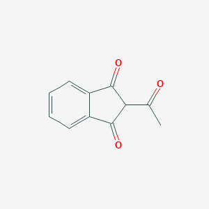 B073857 2-Acetyl-1H-indene-1,3(2H)-dione CAS No. 1133-72-8