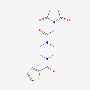 molecular formula C15H17N3O4S B7442481 1-[2-Oxo-2-[4-(thiophene-2-carbonyl)piperazin-1-yl]ethyl]pyrrolidine-2,5-dione 