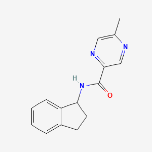 molecular formula C15H15N3O B7457801 N-(2,3-dihydro-1H-inden-1-yl)-5-methylpyrazine-2-carboxamide 