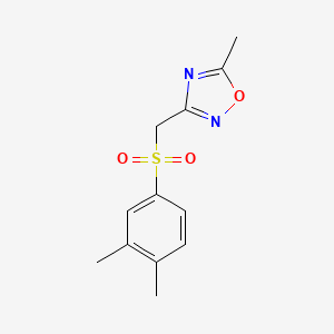 molecular formula C12H14N2O3S B7529492 3-[(3,4-Dimethylphenyl)sulfonylmethyl]-5-methyl-1,2,4-oxadiazole 