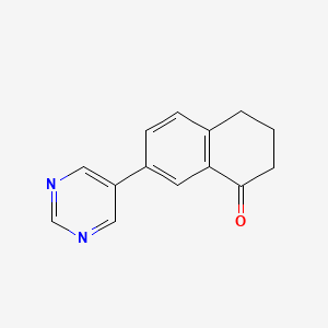 molecular formula C14H12N2O B7637817 7-pyrimidin-5-yl-3,4-dihydro-2H-naphthalen-1-one 