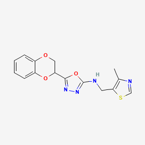 molecular formula C15H14N4O3S B7654223 5-(2,3-dihydro-1,4-benzodioxin-3-yl)-N-[(4-methyl-1,3-thiazol-5-yl)methyl]-1,3,4-oxadiazol-2-amine 