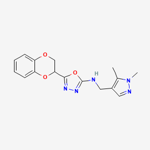 molecular formula C16H17N5O3 B7655064 5-(2,3-dihydro-1,4-benzodioxin-3-yl)-N-[(1,5-dimethylpyrazol-4-yl)methyl]-1,3,4-oxadiazol-2-amine 