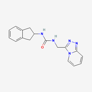 molecular formula C17H17N5O B7655595 1-(2,3-dihydro-1H-inden-2-yl)-3-([1,2,4]triazolo[4,3-a]pyridin-3-ylmethyl)urea 