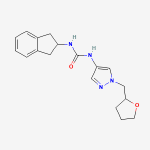 1-(2,3-dihydro-1H-inden-2-yl)-3-[1-(oxolan-2-ylmethyl)pyrazol-4-yl]urea