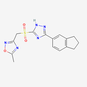 molecular formula C15H15N5O3S B7679639 3-[[3-(2,3-dihydro-1H-inden-5-yl)-1H-1,2,4-triazol-5-yl]sulfonylmethyl]-5-methyl-1,2,4-oxadiazole 