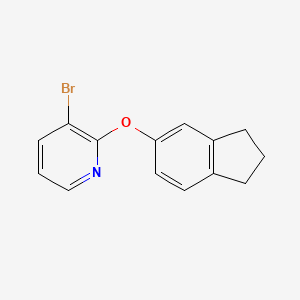 molecular formula C14H12BrNO B7869540 3-Bromo-2-((2,3-dihydro-1H-inden-5-yl)oxy)pyridine 