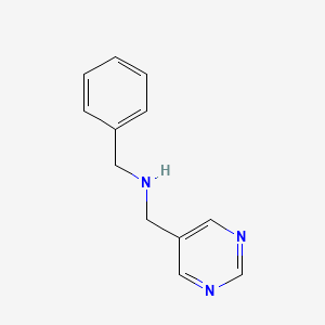 molecular formula C12H13N3 B7875276 Benzyl[(pyrimidin-5-yl)methyl]amine 