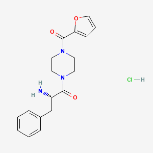 molecular formula C18H22ClN3O3 B7945752 (2S)-2-amino-1-[4-(furan-2-carbonyl)piperazin-1-yl]-3-phenylpropan-1-one;hydrochloride 