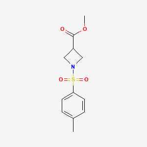 molecular formula C12H15NO4S B7960741 Methyl 1-[(4-methylbenzene)sulfonyl]azetidine-3-carboxylate 