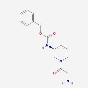 molecular formula C15H21N3O3 B7985103 [(S)-1-(2-Amino-acetyl)-piperidin-3-yl]-carbamic acid benzyl ester 
