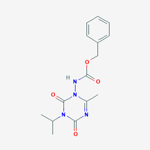 molecular formula C15H18N4O4 B8041734 benzyl N-(6-methyl-2,4-dioxo-3-propan-2-yl-1,3,5-triazin-1-yl)carbamate 