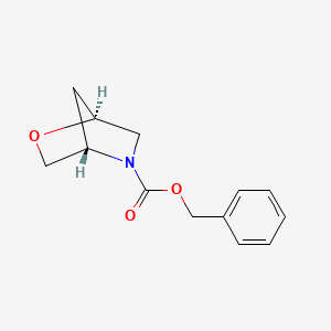 molecular formula C13H15NO3 B8055386 (1S,4S)-benzyl 2-oxa-5-azabicyclo[2.2.1]heptane-5-carboxylate 