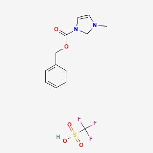 molecular formula C13H15F3N2O5S B8066605 3-[(benzyloxy)carbonyl]-1-methyl-2,3-dihydro-1H-imidazol-1-ium trifluoromethanesulfonate 
