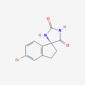 molecular formula C11H9BrN2O2 B8090149 (R)-5'-Bromo-2',3'-dihydrospiro[imidazolidine-4,1'-indene]-2,5-dione 