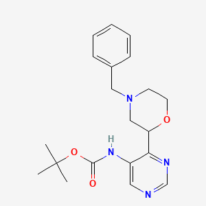 molecular formula C20H26N4O3 B8098630 Tert-Butyl (4-(4-Benzylmorpholin-2-Yl)Pyrimidin-5-Yl)Carbamate 