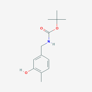 molecular formula C13H19NO3 B8100713 tert-butyl N-[(3-hydroxy-4-methylphenyl)methyl]carbamate 